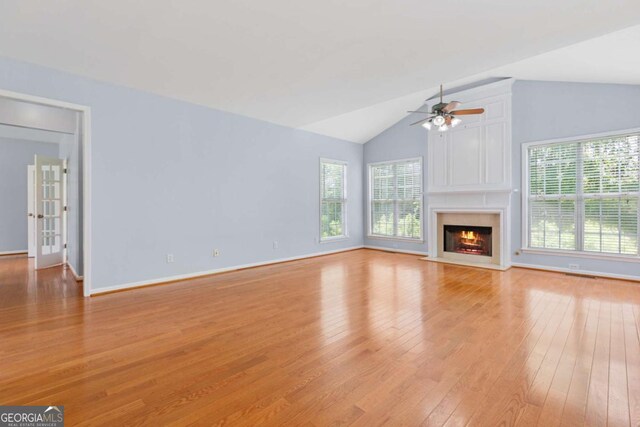5003 Pacific Dunes Dr, Suwanee, GA 30024 - unfurnished living room featuring light wood-style flooring, healthy amount of natural light, a ceiling fan, lofted ceiling, and a fireplace with flush hearth