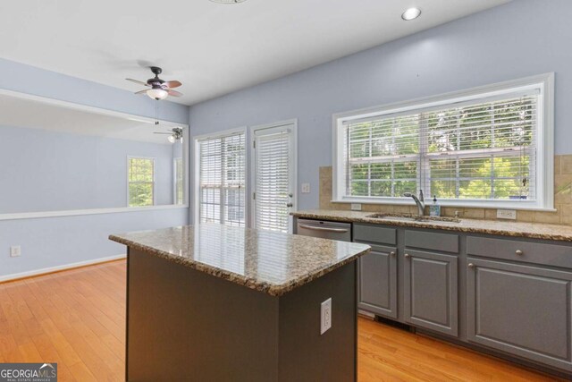 5003 Pacific Dunes Dr, Suwanee, GA 30024 - kitchen with gray cabinets, a kitchen island, a ceiling fan, light stone countertops, and dishwasher