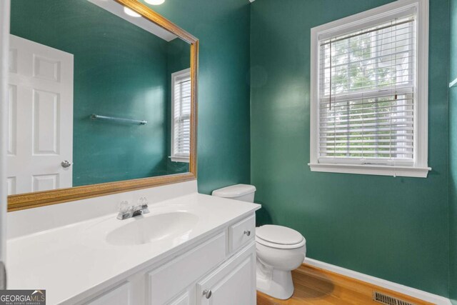 5003 Pacific Dunes Dr, Suwanee, GA 30024 - half bath featuring vanity and wood finished floors