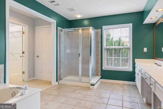 5003 Pacific Dunes Dr, Suwanee, GA 30024 - full bath featuring vanity, a stall shower, tile patterned flooring, a bath, and a walk in closet