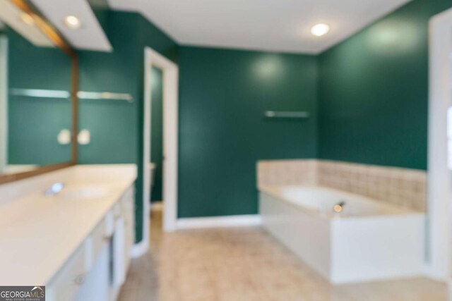 5003 Pacific Dunes Dr, Suwanee, GA 30024 - bathroom featuring vanity, a garden tub, and recessed lighting
