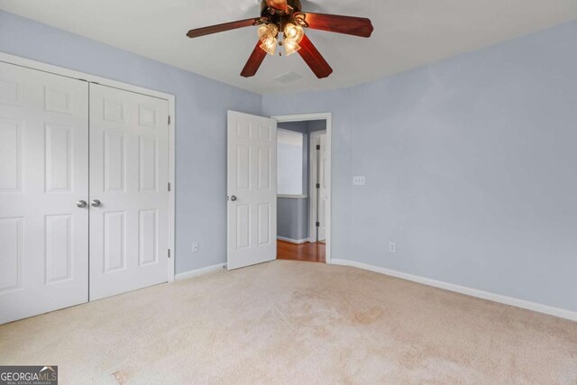 5003 Pacific Dunes Dr, Suwanee, GA 30024 - unfurnished bedroom with carpet flooring, a closet, and ceiling fan