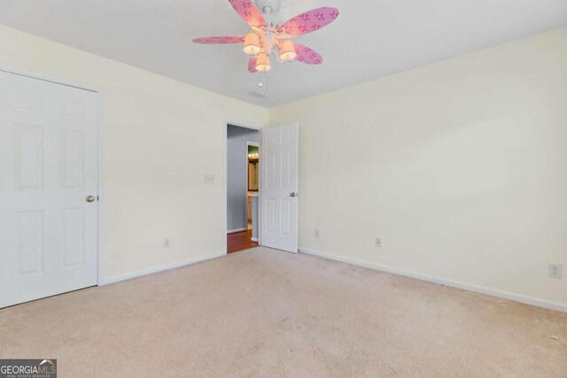 5003 Pacific Dunes Dr, Suwanee, GA 30024 - unfurnished bedroom featuring carpet flooring and a ceiling fan