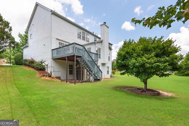5003 Pacific Dunes Dr, Suwanee, GA 30024 - back of property featuring stairway, a deck, a chimney, and a yard