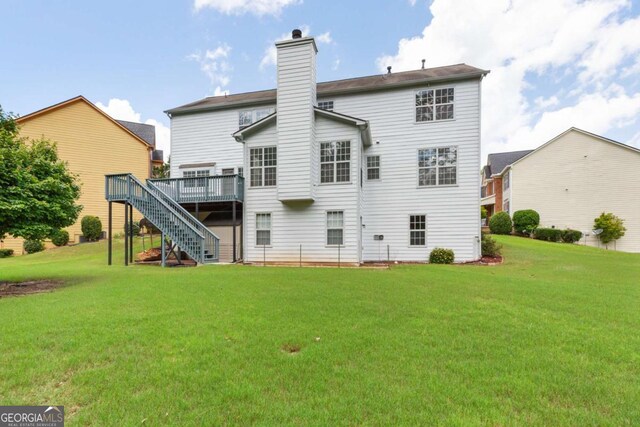5003 Pacific Dunes Dr, Suwanee, GA 30024 - rear view of property featuring stairway, a wooden deck, a lawn, and a chimney