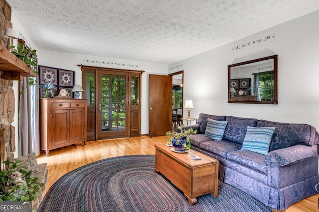 3754 Wyntuck Cir NW, Kennesaw, GA 30152 - living area featuring light wood finished floors and a textured ceiling