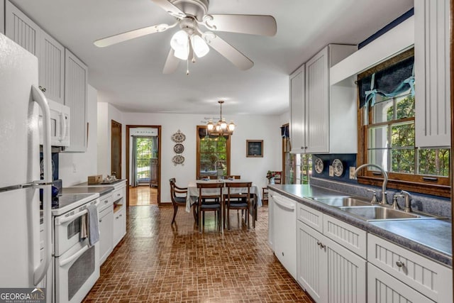 3754 Wyntuck Cir NW, Kennesaw, GA 30152 - kitchen featuring white appliances, a chandelier, ceiling fan, brick patterned floors, and hanging light fixtures