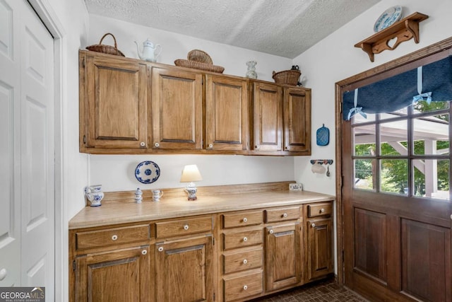 3754 Wyntuck Cir NW, Kennesaw, GA 30152 - kitchen with light countertops, brown cabinets, and a textured ceiling