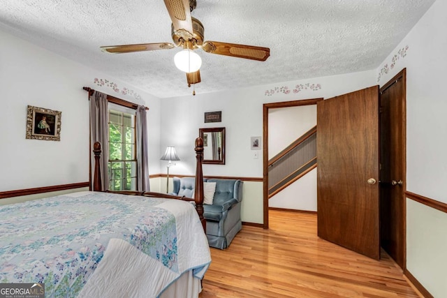 3754 Wyntuck Cir NW, Kennesaw, GA 30152 - bedroom with a textured ceiling, light wood finished floors, and ceiling fan