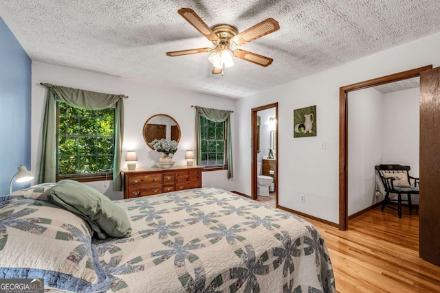 3754 Wyntuck Cir NW, Kennesaw, GA 30152 - bedroom featuring light wood-style floors, a textured ceiling, a ceiling fan, and ensuite bathroom