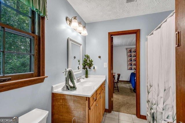 3754 Wyntuck Cir NW, Kennesaw, GA 30152 - bathroom with vanity, a textured ceiling, tile patterned floors, healthy amount of natural light, and a shower with curtain