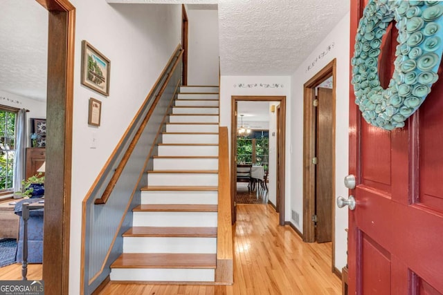 3754 Wyntuck Cir NW, Kennesaw, GA 30152 - foyer entrance featuring a textured ceiling, stairway, and light wood-style floors