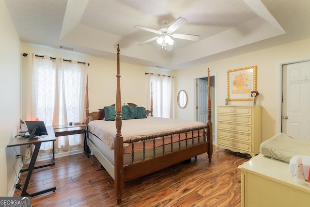 3030 Thornberry Cir, Phenix City, AL 36867 - bedroom with a tray ceiling, light wood-type flooring, and a ceiling fan