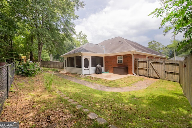 3030 Thornberry Cir, Phenix City, AL 36867 - rear view of property featuring a patio, a sunroom, brick siding, a fenced backyard, and a gate