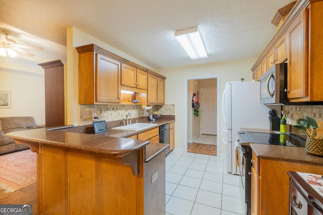 3030 Thornberry Cir, Phenix City, AL 36867 - kitchen with stainless steel microwave, range with electric cooktop, dishwashing machine, a kitchen bar, and a textured ceiling