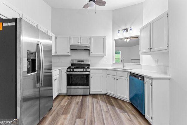 165 Lost Lake Trl, Villa Rica, GA 30180 - kitchen with stainless steel appliances, ceiling fan, under cabinet range hood, and light countertops