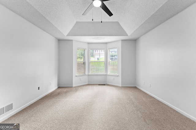 165 Lost Lake Trl, Villa Rica, GA 30180 - carpeted empty room featuring a textured ceiling, a ceiling fan, and a tray ceiling