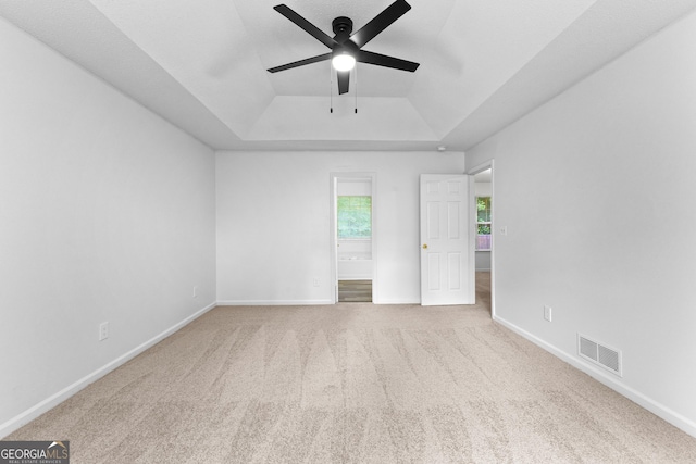 165 Lost Lake Trl, Villa Rica, GA 30180 - unfurnished bedroom featuring a tray ceiling, carpet, and connected bathroom