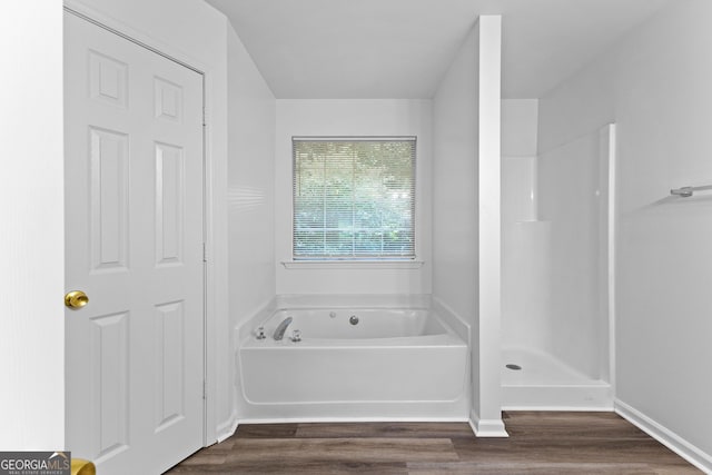 165 Lost Lake Trl, Villa Rica, GA 30180 - bathroom featuring wood finished floors, a bath, and a shower