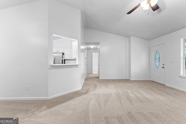 165 Lost Lake Trl, Villa Rica, GA 30180 - unfurnished living room featuring light colored carpet, lofted ceiling, and a ceiling fan