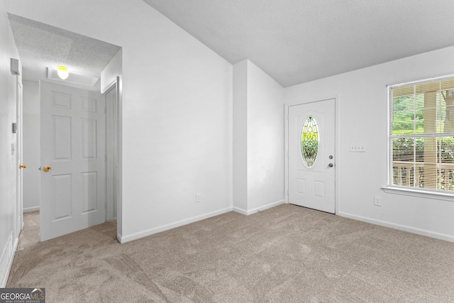 165 Lost Lake Trl, Villa Rica, GA 30180 - carpeted entrance foyer with a textured ceiling and vaulted ceiling