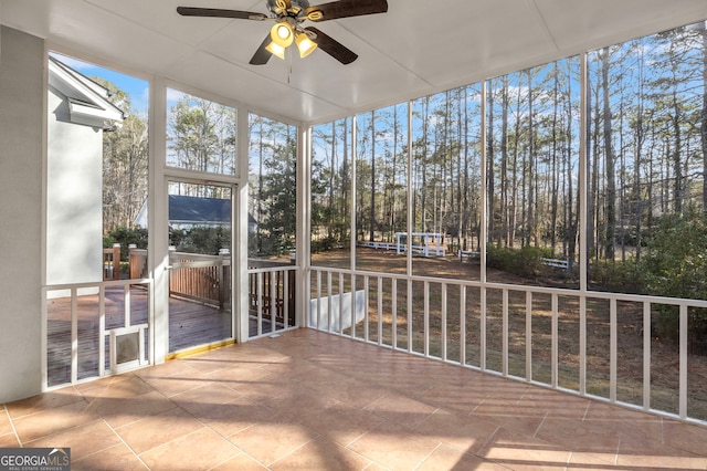 55 Summerhill Pl, Newnan, GA 30263 - unfurnished sunroom featuring a ceiling fan and view of scattered trees