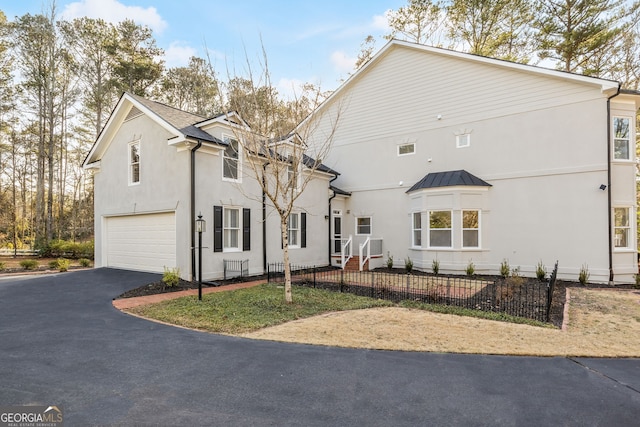 55 Summerhill Pl, Newnan, GA 30263 - view of front of house featuring driveway, a garage, stucco siding, a standing seam roof, and a metal roof