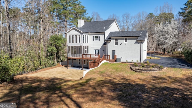 55 Summerhill Pl, Newnan, GA 30263 - rear view of house with a shingled roof, a chimney, a wooden deck, a patio area, and a yard