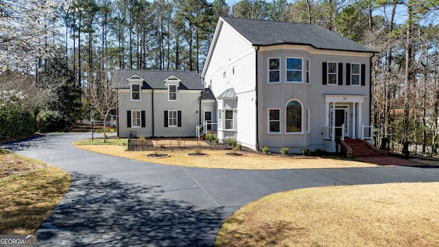 55 Summerhill Pl, Newnan, GA 30263 - view of front facade with stucco siding, asphalt driveway, view of wooded area, and roof with shingles