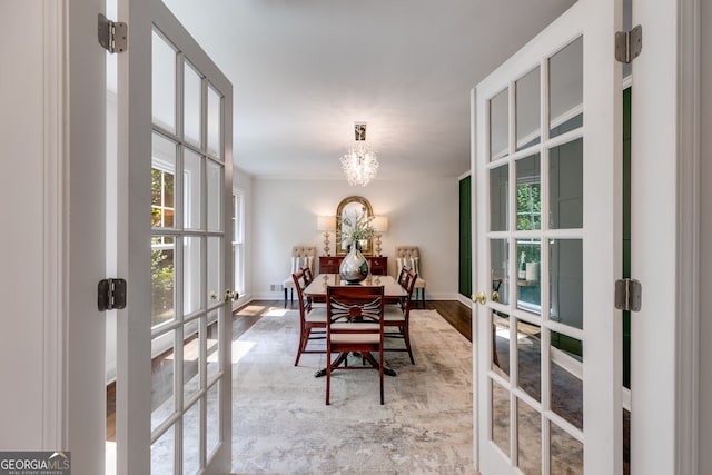 7250 Hunters Branch Dr, Atlanta, GA 30328 - dining space featuring french doors, wood finished floors, and a chandelier