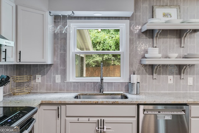 7250 Hunters Branch Dr, Atlanta, GA 30328 - kitchen with stainless steel appliances, tasteful backsplash, white cabinets, light stone counters, and exhaust hood