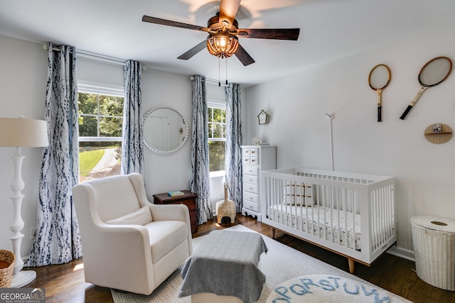 7250 Hunters Branch Dr, Atlanta, GA 30328 - bedroom featuring a nursery area, multiple windows, and wood finished floors