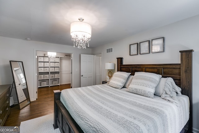 7250 Hunters Branch Dr, Atlanta, GA 30328 - bedroom with a chandelier, dark wood-style floors, and a spacious closet