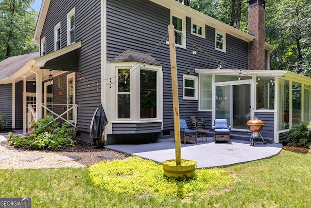 7250 Hunters Branch Dr, Atlanta, GA 30328 - rear view of property with a chimney, a sunroom, a patio, and a yard