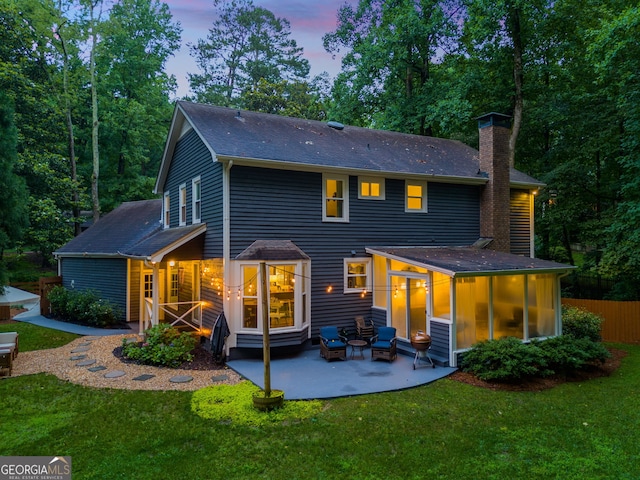 7250 Hunters Branch Dr, Atlanta, GA 30328 - back of property at dusk with roof with shingles, a chimney, and a patio area