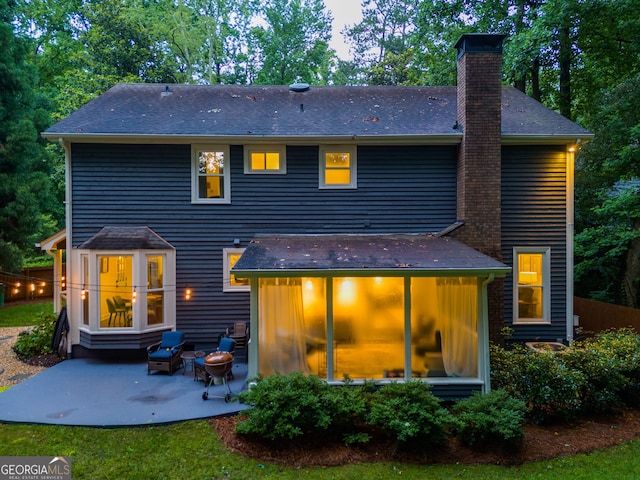 7250 Hunters Branch Dr, Atlanta, GA 30328 - back of house featuring a chimney, a patio area, and roof with shingles