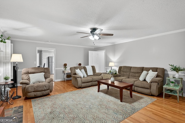 1505 Misty Valley Dr, Chatsworth, GA 30705 - living room with ceiling fan, wood finished floors, a textured ceiling, and ornamental molding