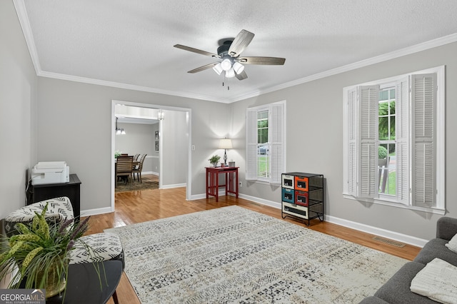 1505 Misty Valley Dr, Chatsworth, GA 30705 - sitting room featuring plenty of natural light, ornamental molding, wood finished floors, a ceiling fan, and a textured ceiling