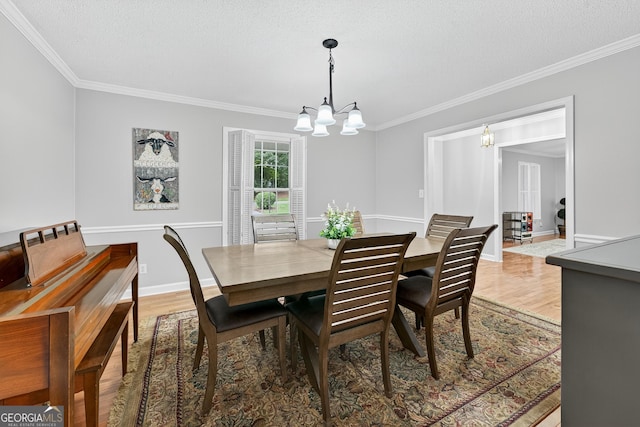 1505 Misty Valley Dr, Chatsworth, GA 30705 - dining room featuring a chandelier, ornamental molding, wood finished floors, and a textured ceiling