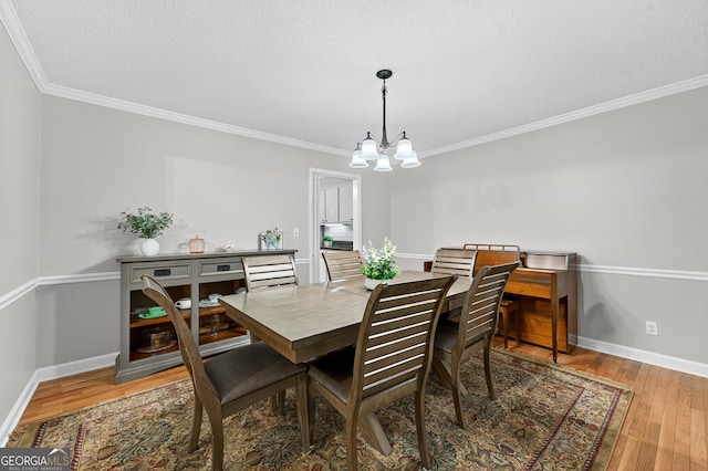 1505 Misty Valley Dr, Chatsworth, GA 30705 - dining area featuring a chandelier, crown molding, and wood finished floors