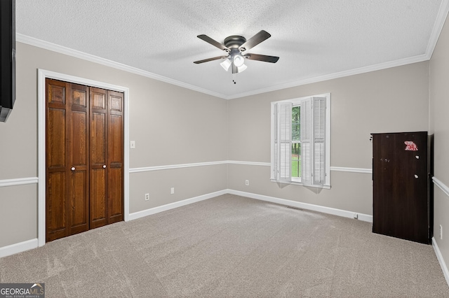 1505 Misty Valley Dr, Chatsworth, GA 30705 - unfurnished bedroom with a textured ceiling, crown molding, carpet floors, ceiling fan, and a closet