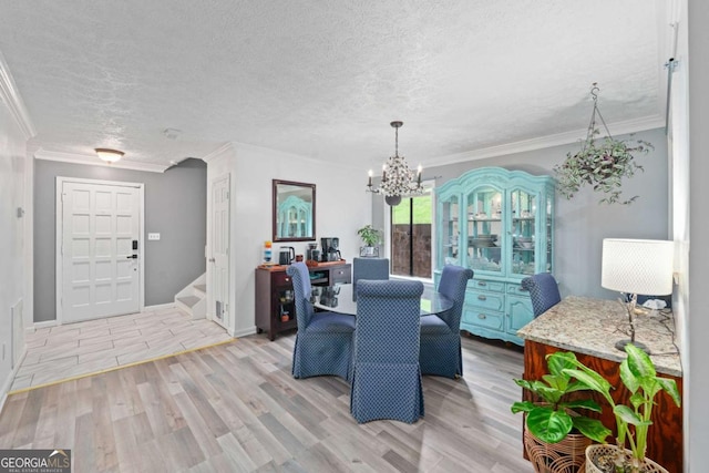 834 Lake Hollow Blvd SW, Marietta, GA 30064 - dining room with light wood-style flooring, stairs, a textured ceiling, a chandelier, and crown molding