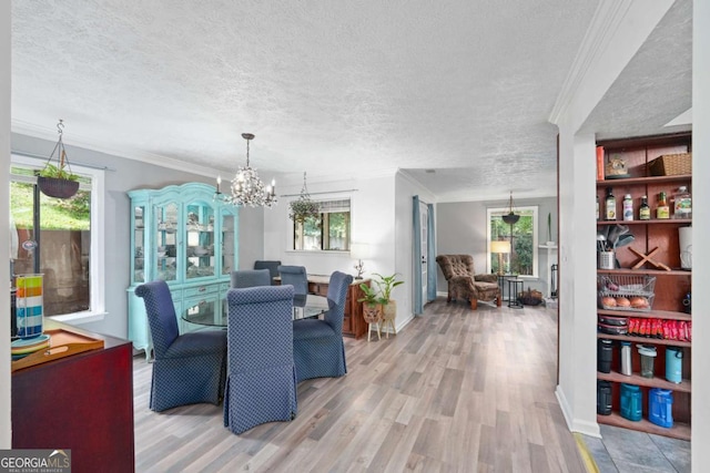 834 Lake Hollow Blvd SW, Marietta, GA 30064 - dining room featuring a textured ceiling, plenty of natural light, crown molding, wood finished floors, and a chandelier