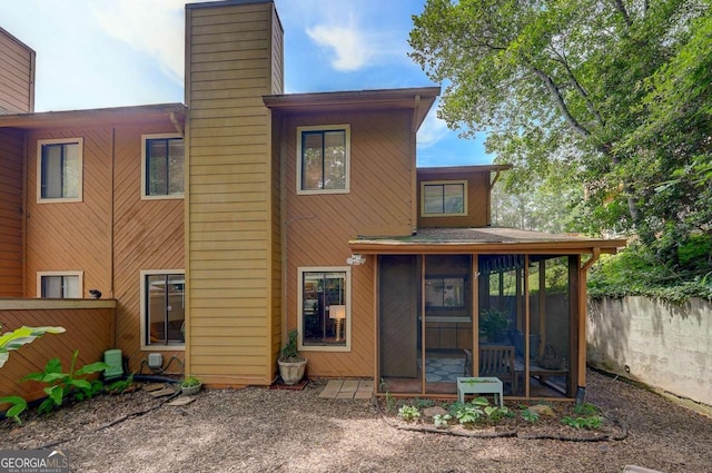 834 Lake Hollow Blvd SW, Marietta, GA 30064 - back of property with a chimney and a sunroom