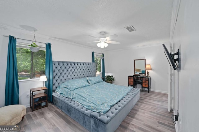834 Lake Hollow Blvd SW, Marietta, GA 30064 - bedroom with ornamental molding, wood finished floors, a textured ceiling, and a ceiling fan