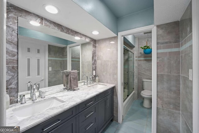 834 Lake Hollow Blvd SW, Marietta, GA 30064 - bathroom featuring double vanity, tile walls, and combined bath / shower with glass door