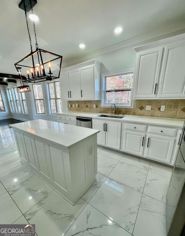 3499 Lake Mill Rd, Buford, GA 30519 - kitchen with stainless steel dishwasher, a chandelier, light countertops, white cabinets, and light marble finish floors