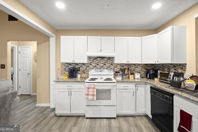7030 Kingston Ln, Mcdonough, GA 30253 - kitchen with white electric range, black dishwasher, light wood-style floors, white cabinets, and recessed lighting