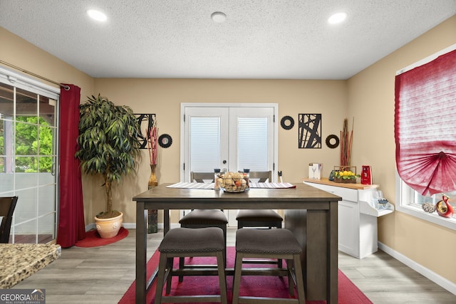 7030 Kingston Ln, Mcdonough, GA 30253 - dining space featuring french doors, a textured ceiling, light wood-style floors, and recessed lighting