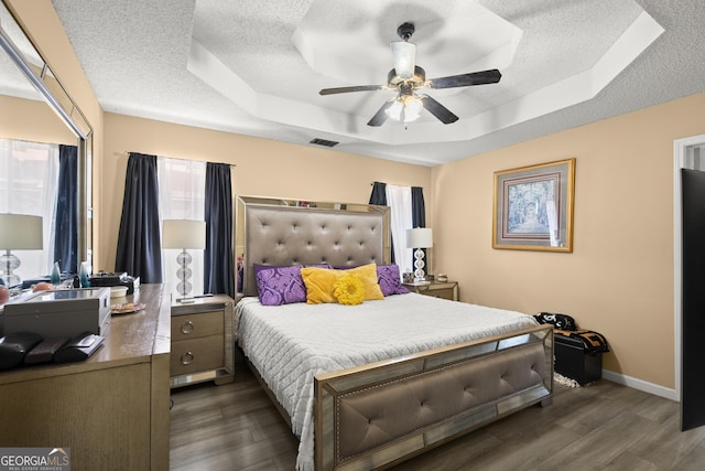 7030 Kingston Ln, Mcdonough, GA 30253 - bedroom featuring a raised ceiling, a textured ceiling, wood finished floors, and a ceiling fan